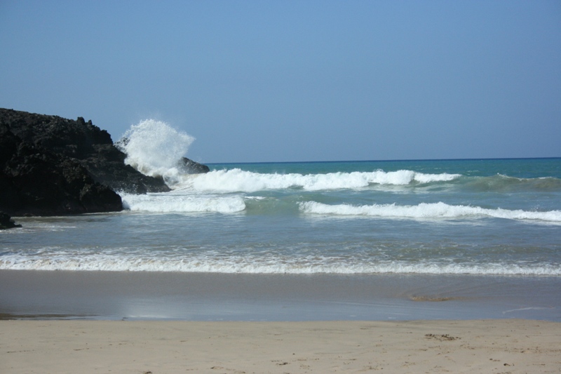 photo of a large wave crashing on lava at Hapuna Beach in Hawaii